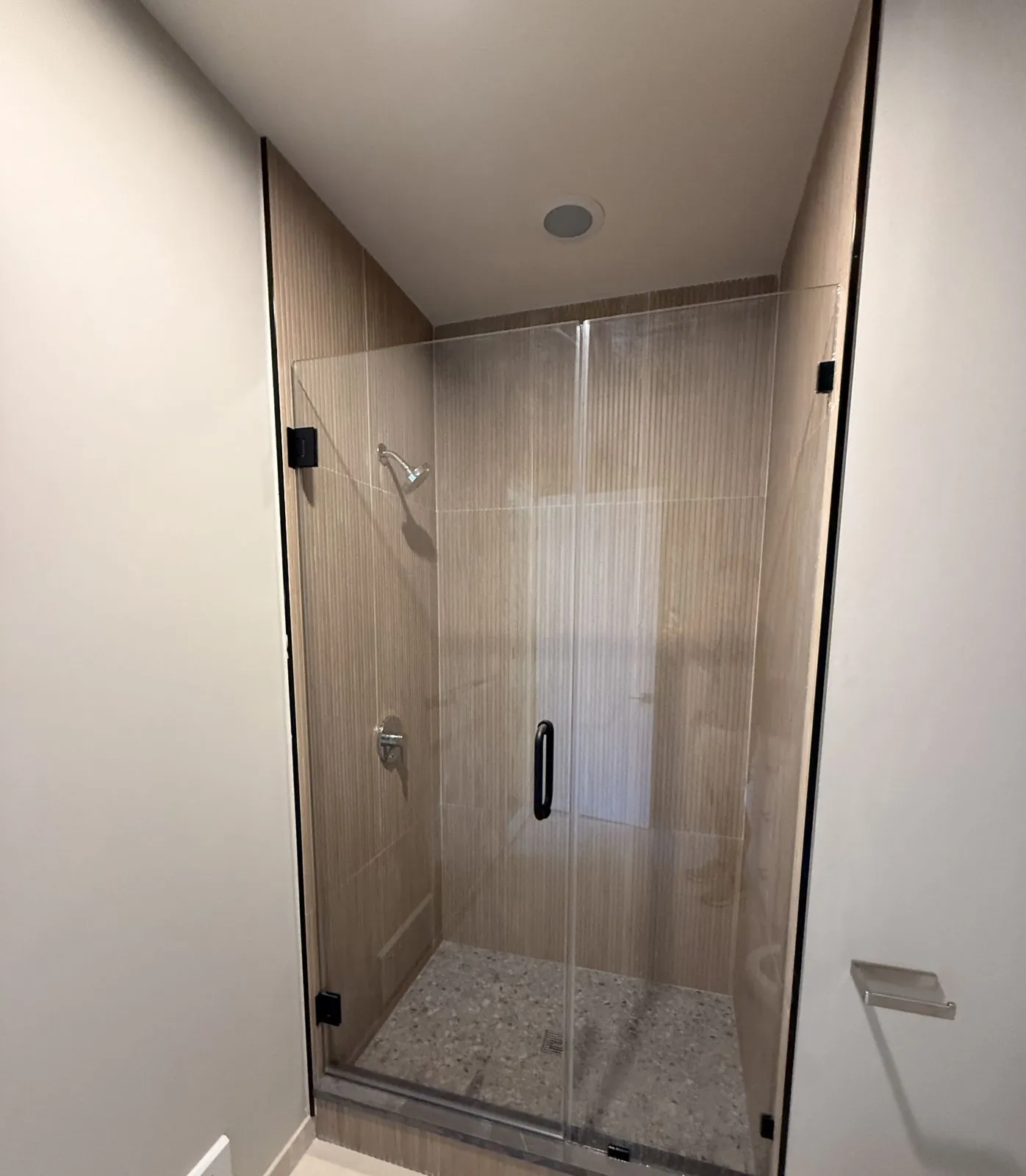 Glass shower with wood-look fluted tile