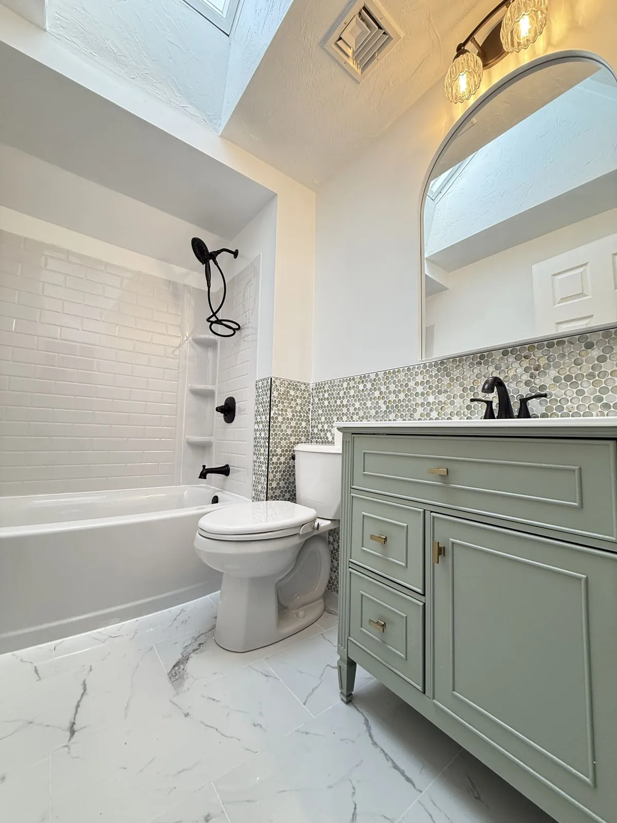 Sage vanity, penny tile & subway tile tub surround